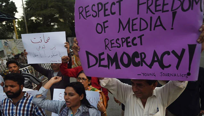 Pakistani journalists and civil society activists hold placards against the attack on a senior journalist of a local newspaper in Karachi. — AFP/File