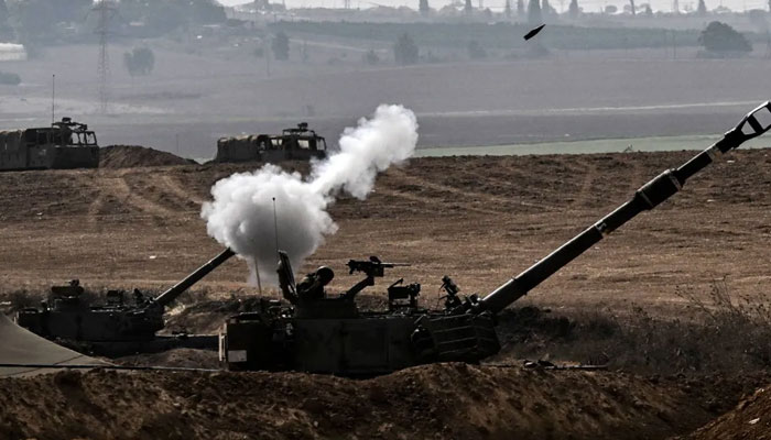 An Israeli Army M109 155mm self-propelled howitzer fires rounds toward the Gaza Strip from a position in southern Israel across the border on October 28, 2023. — AFP