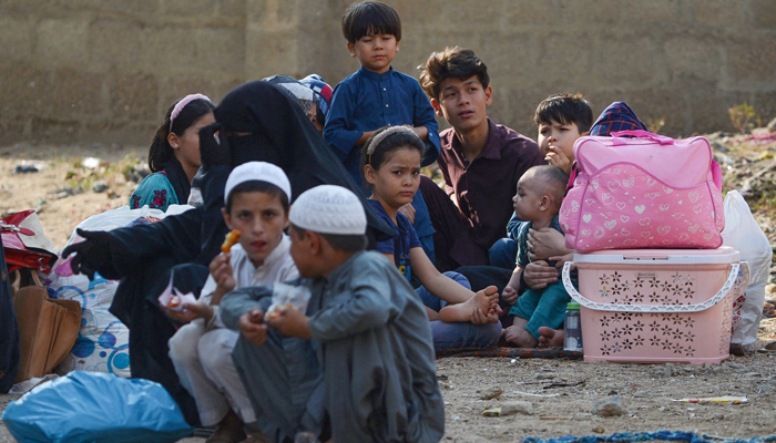 Afghan refugees wait at the Karachi bus terminal to depart for Afghanistan, in Sindh province on October 31, 2023. — AFP