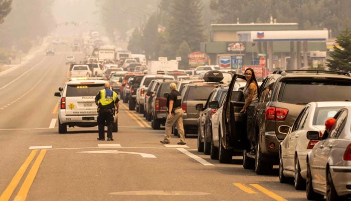 Residents are stuck in gridlock trying to evacuate as the Caldor Fire approaches in South Lake Tahoe, Calif., on Monday. At least 650 structures have burned and thousands more are threatened as the fire moves into the resort community. — AFP