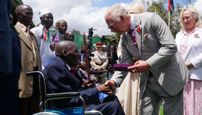 King Charles met war veteran Samweli Mburia at a Commonwealth cemetery. — AFP