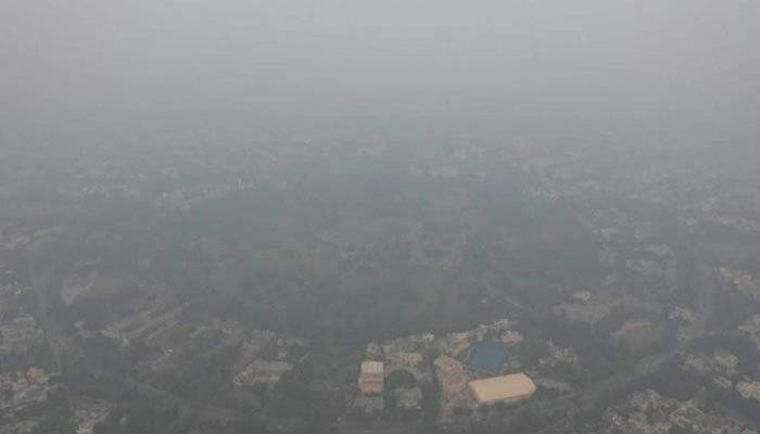 The Model Town Park of Lahore can be seen blanketed in smog on November 1, 2023. —x/. cfawad