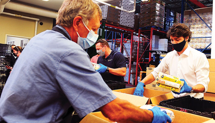 Canadian PM Justin Trudeau volunteers at a food bank in Gatineau, Quebec.—AFP/File