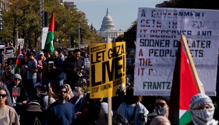 The US Capitol building is seen in the distance as demonstrators gather in Freedom Plaza during a rally in support of Palestinians in Washington, DC, on November 4, 2023. — AFP