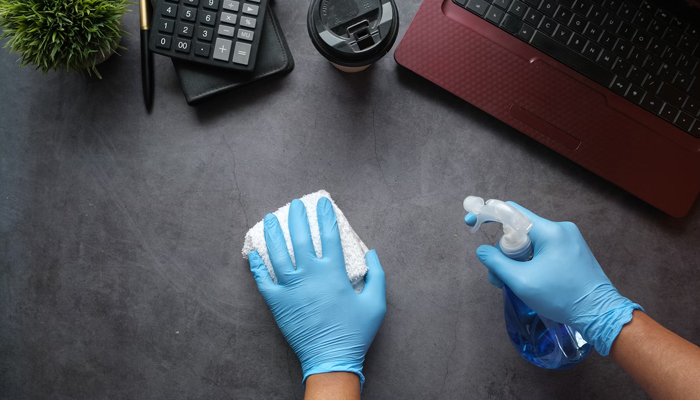 A representational image shows a person cleaning a surface. — Unsplash/File