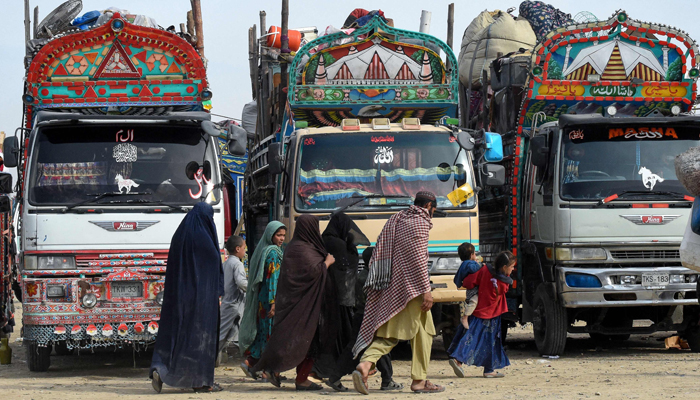 In this photo taken on November 4, 2023, Afghan refugees arrive at the Chaman border before departing for Afghanistan. — AFP