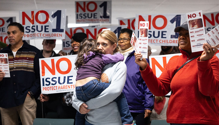 Canvassers hold pro-life signs at Columbus Christian Center ahead of Election Day during a pro-life canvasing meeting in Columbus, Ohio on November 4, 2023. — AFP