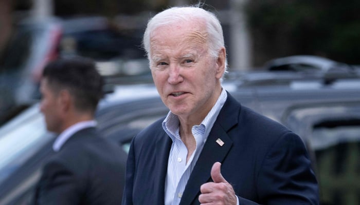 US President Joe Biden gives a thumbs up as he leaves St. Edmond Roman Catholic Church in Rehoboth Beach, Delaware, on November 4, 2023. — AFP