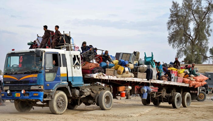 Afghan refugees with their belongings arrive on a truck from Pakistan, at a registration centre near the Afghanistan-Pakistan border in the Spin Boldak district of Kandahar province on November 6, 2023. — AFP