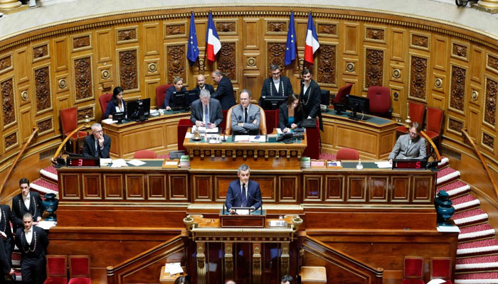 French Interior Minister Gerald Darmanin (C) speaks in the French Senate during a debate on the French Governments immigration bill, in Paris. — AFP