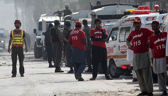 This image shows rescue workers looking on. — AFP/File