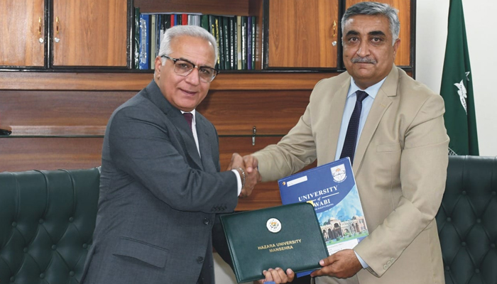 VC of the University of Hazara Dr Mohsin Nawaz (R) and VC of the University of Swabi Dr Nasir Jamal Khattak shake hands after signing the MoU on November 6, 2023. — Facebook/Hazara University