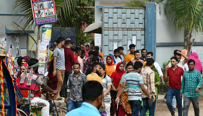 Garments workers walk off a factory at lunch break in Ashulia on November 8, 2023, a day after Minimum Wage Board authority declared the minimum wage of 12,500 taka ($113) for garment workers. — AFP