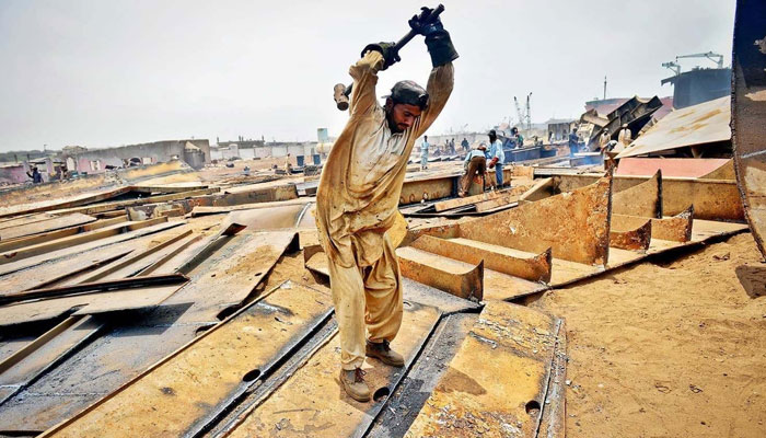 A labourer works at a construction site. — AFP/File