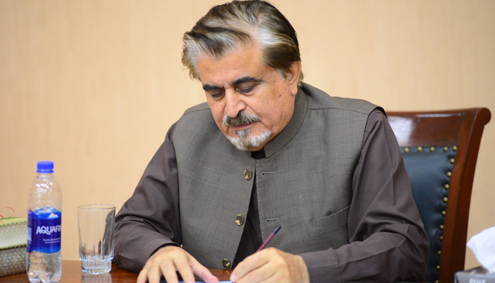 Federal Minister for National Heritage and Culture, Syed Jamal Shah signs a document in this image released on November 12, 2023. — Facebook/Jamal Shah