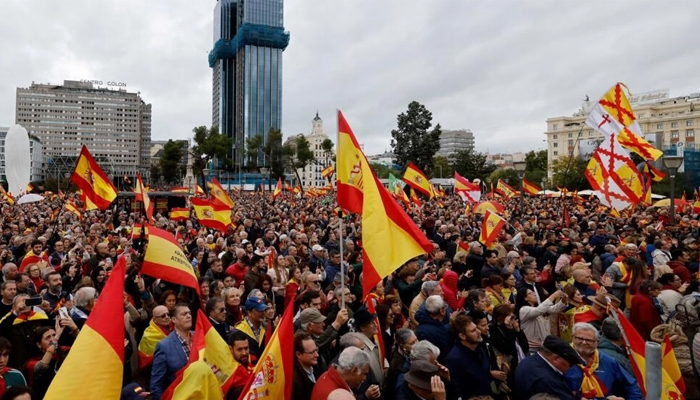 Protestors wave Spanish flags at a Madrid protest against plans to grant an amnesty to Catalan separatists. — AFP