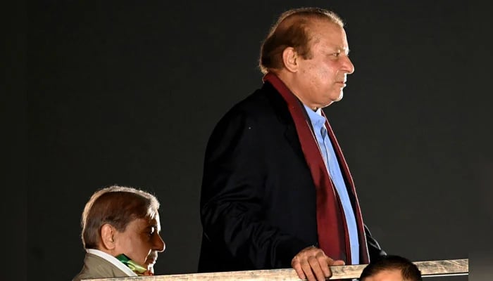 Former prime ministers Nawaz Sharif (R) arrives with his brother Shehbaz Sharif at Minar-e-Pakistan in Lahore on October 21, 2023. — AFP