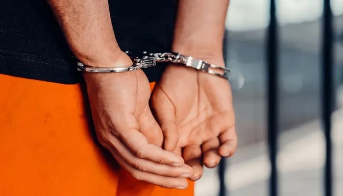 A representational image of a person handcuffed. — Pexels/File