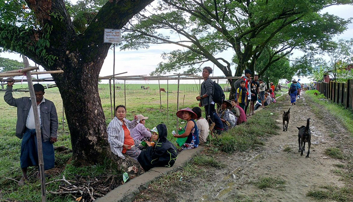 People flee from a village after renewed fighting between Myanmars military and the Arakan Army in Pauktaw Township in western Rakhine State on November 19, 2023. — AFP