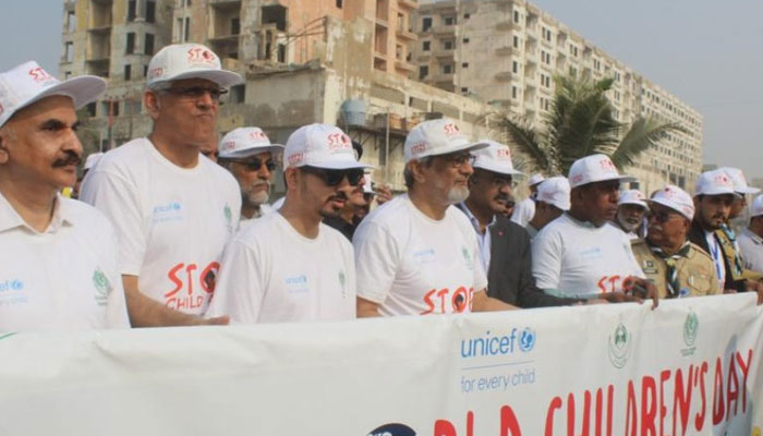 Caretaker chief minister Justice (retd) Maqbool Baqar can be seen attending the World Childrens Day Awareness Walk. —x/SindhChild