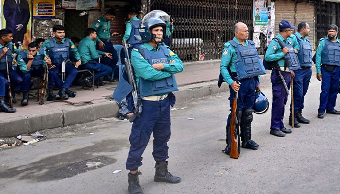 Police personnel stand guard in front of the Bangladesh Nationalist Party (BNP) headquarters in Dhaka on November 19, 2023, during a nationwide strike called by BNP activists.  — AFP File
