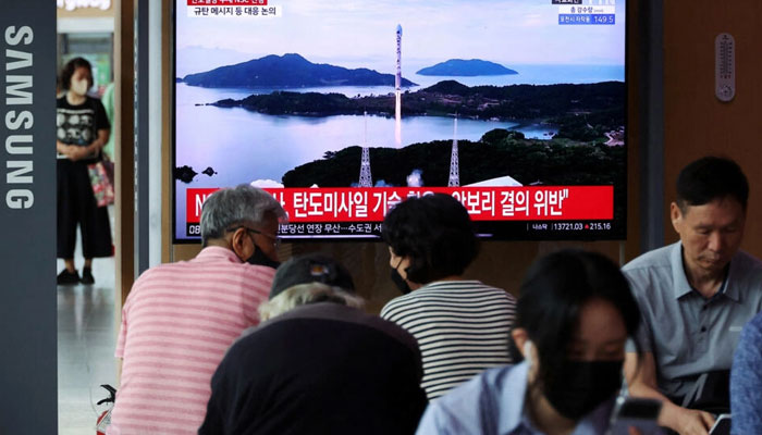 Passengers watch a TV broadcasting a news report on North Korea firing a space rocket, at a railway station in Seoul, South Korea, August 24, 2023. — AFP File