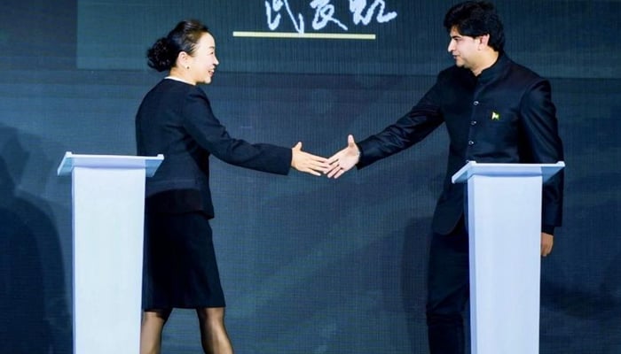 This image shows the Chinese and Pakistani officials stepping forward to shake hand s after signing an MOU on November 22, 2023. — Facebook/Khyber Pakhtunkhwa Board of Investment & Trade