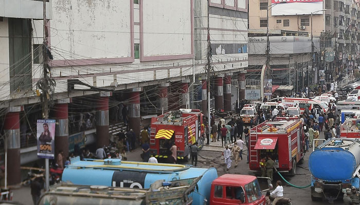 Firefighters douse the fire at a shopping mall in Karachi on November 25, 2023. — AFP