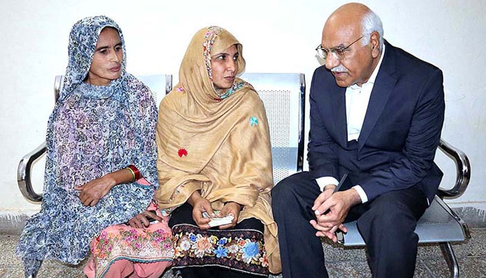 In this picture, the chairperson of the Benazir Income Support Program Dr Muhammad Amjad Saqib interacts with women on November 21, 2023.— APP