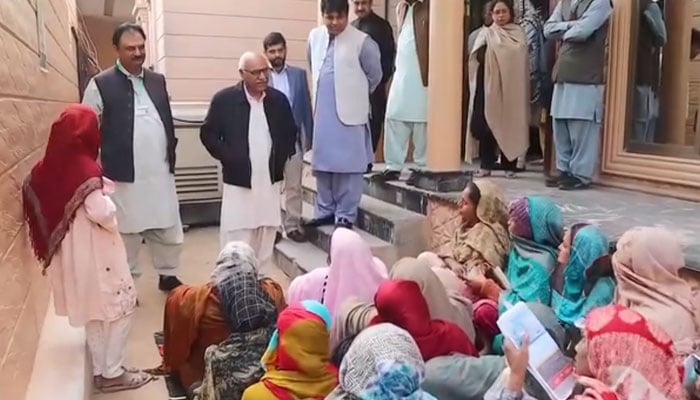 Benazir Income Support Programme (BISP) Chairman Dr. Muhammad Amjad Saqib talks to women as he visits  BISP Zonal Office South Punjab and District Office Multan on Dec 1, 2023. —Facebook/bispinfo