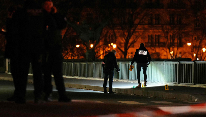 Forensic police work at the scene of a stabbing in Paris on December 2, 2023. — AFP