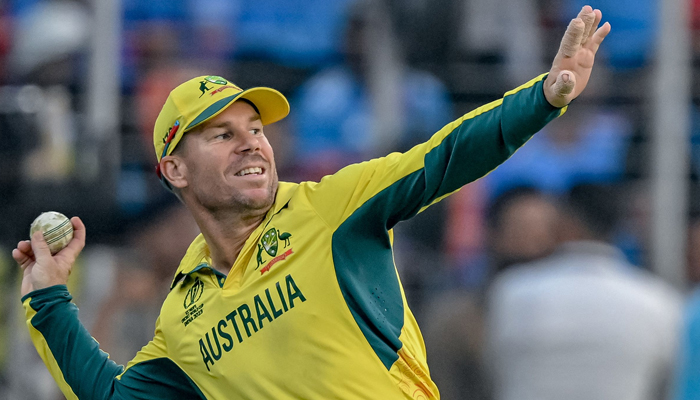 Australias David Warner throws the ball during the 2023 ICC Mens Cricket World Cup ODI final between India and Australia at the Narendra Modi Stadium in Ahmedabad on November 19, 2023. — AFP