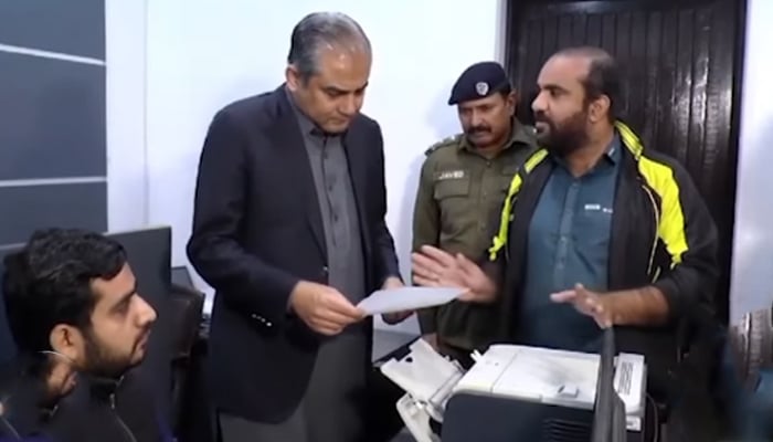 Punjab Caretaker Chief Minister Mohsin Naqvi listens to a citizen during his surprise visit to Allama Iqbal Town Police Station in this still on December 3, 2023. — Facebook/Govt of Punjab