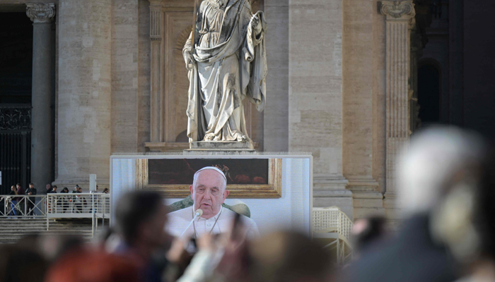 Pope Francis is seen on a giant screen at St. Peters Square in The Vatican as he delivers the Angelus prayer on December 3, 2023. — AFP