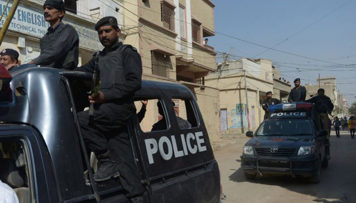 This image shows police personnel on police vehicles. — AFP/File