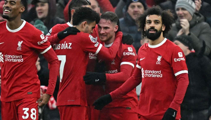 Liverpools Alexis Mac Allister (second right) celebrates with teammates after scoring their second goal during the English Premier League football match between Liverpool and Fulham at Anfield in Liverpool, northwest England, on December 3, 2023. — AFP