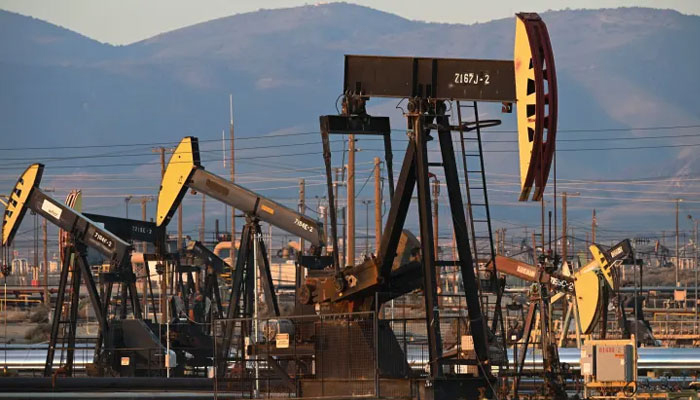 Active pump jacks increase pressure to draw oil toward the surface at the South Belridge Oil Field on February 26, 2022, — AFP