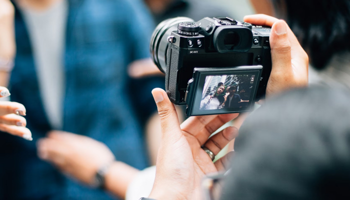 This representational image shows a person capturing a photo. — Unsplash/File