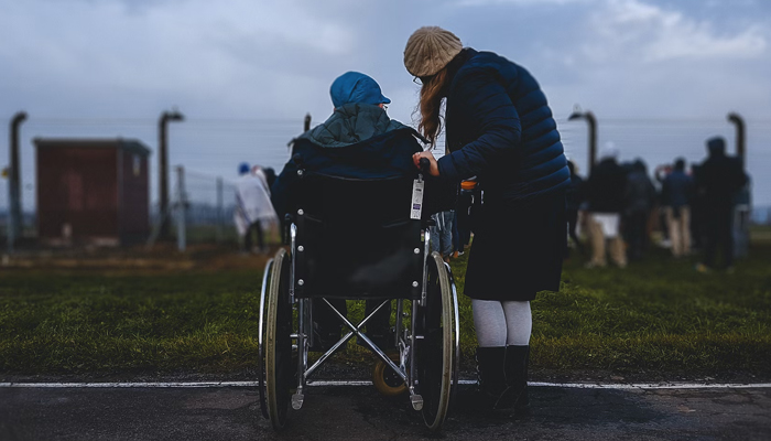 This representational image shows a woman alongside a person in a wheelchair. — Unsplash/File