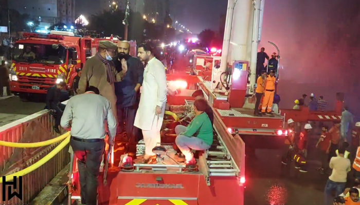 This still shows rescue officials and local people on a fire brigade vehicle after the fire in an upholstery foam shop at the Ayesha Manzil furniture market on December 6, 2023. — Facebook/HASAN WARSI media cell district Central ppp