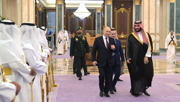 This photograph shows Russias President Vladimir Putin (L) and Saudi Crown Prince Mohammed bin Salman attending a welcoming ceremony ahead of their talks in Riyadh on December 6, 2023. — AFP