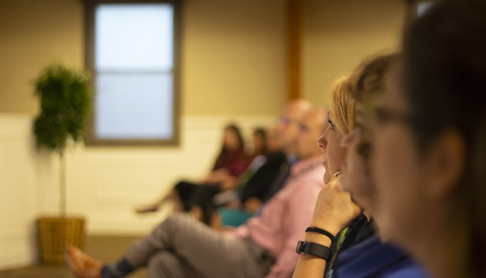 A representational image of people sitting in a ceremony. — Unsplash/File