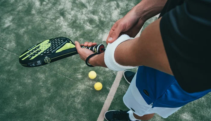 A representational image of a person holding a racket. — Unsplash/File