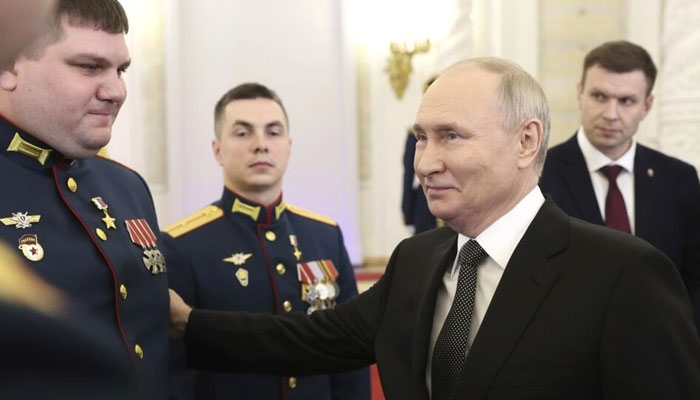 Russian President Vladimir Putin talks with awarded Russian servicemen at the St. George Hall of the Grand Kremlin Palace in Moscow, Russia on Friday, December 8, 2023. — AFP File