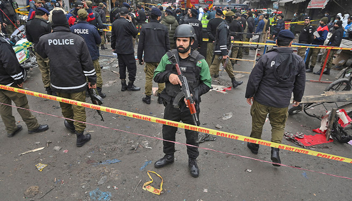 This image shows a Punjab police official standing on alert. — AFP/File