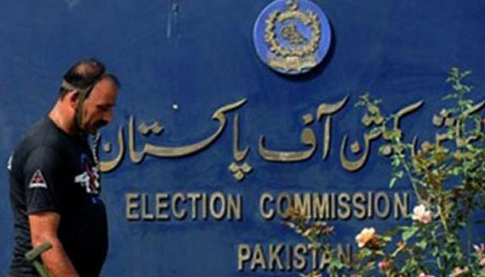 A security guard walks by the Election Commission of Pakistan plaque outside its building in Islamabad. — AFP/File