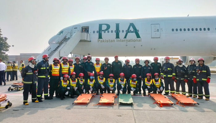 This image shows participants and officials posing for a picture on the occasion of a full-scale Airport Emergency Exercise at Allama Iqbal International Airport on December 12, 2023. — Facebook/Muhammad Farman