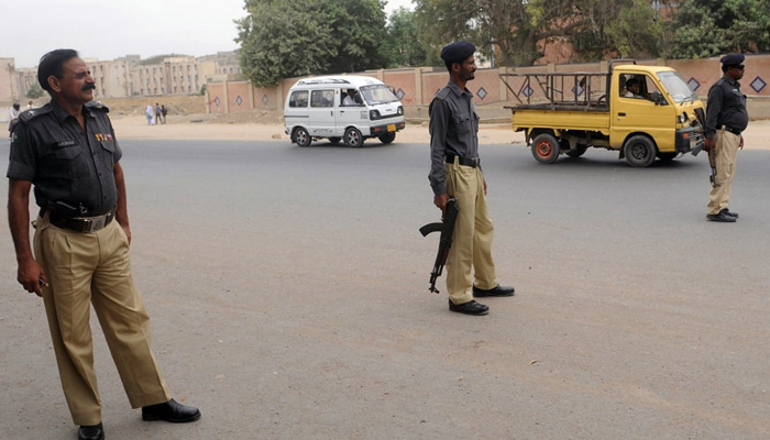 This image shows Karachi Police officers standing alert. — AFP/File