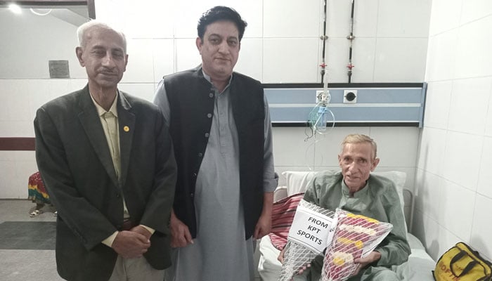 Senior International Technical Personality of Pakistan Boxing, Ali Akbar Shah Qadri (R) holds bouquets in the Hospital on December 15, 2023. — Facebook/Ali Akber Shah Qadri