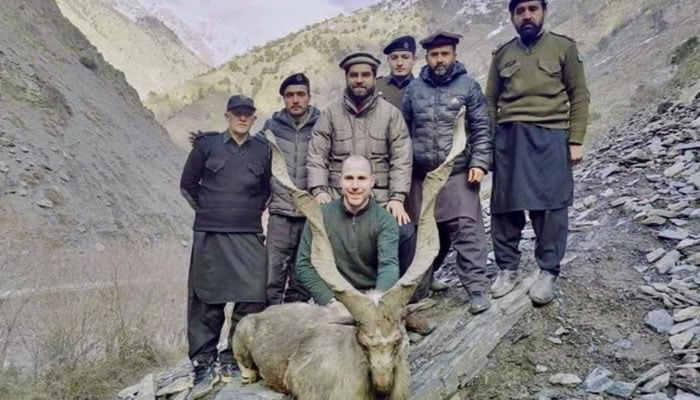 A US citizen Deron James Millman (c) poses for a picture after hunting a Markhor. — Provided by the reporter Arooba Ibrahim